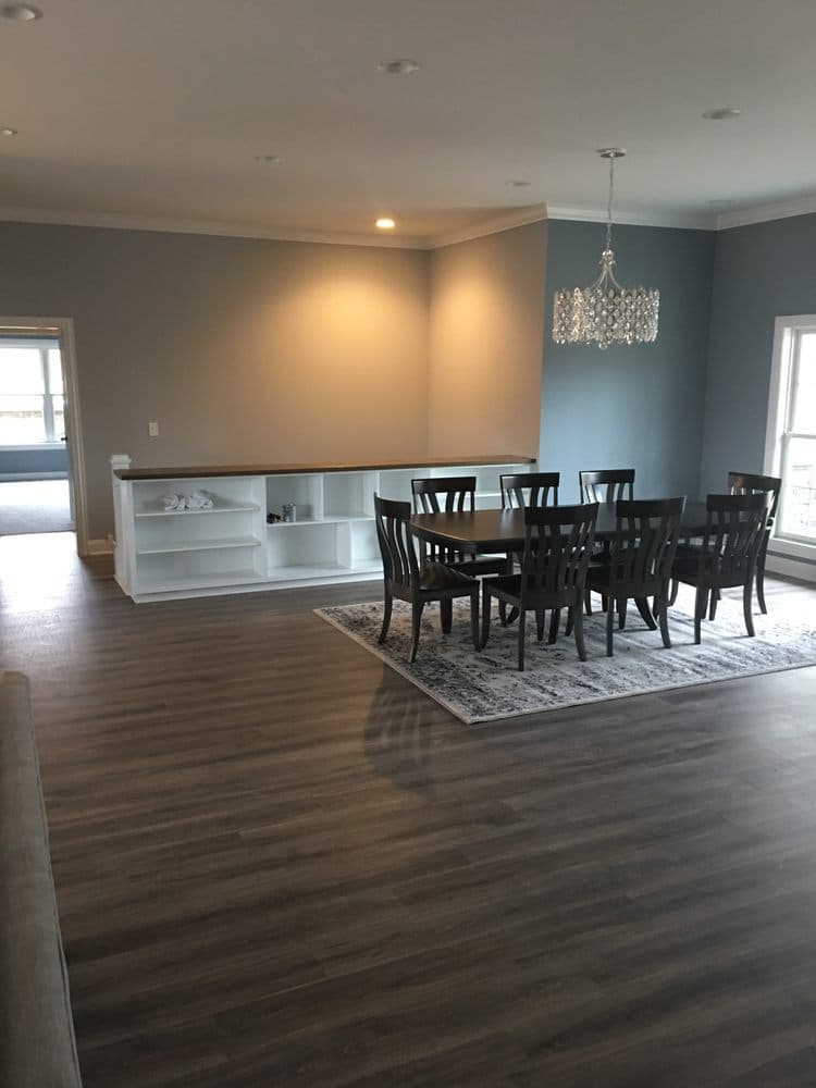 Open dining room with freshly painted gray-blue walls and a built-in shelf
