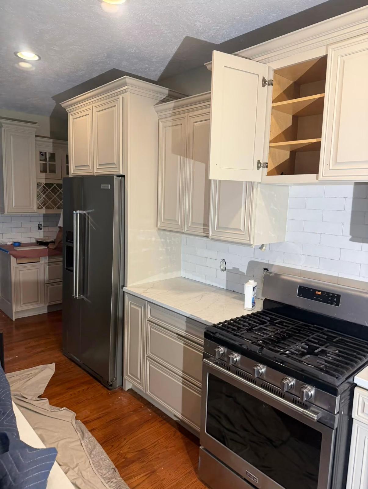 Kitchen cabinets painted a warm cream alongside a subway tile backsplash