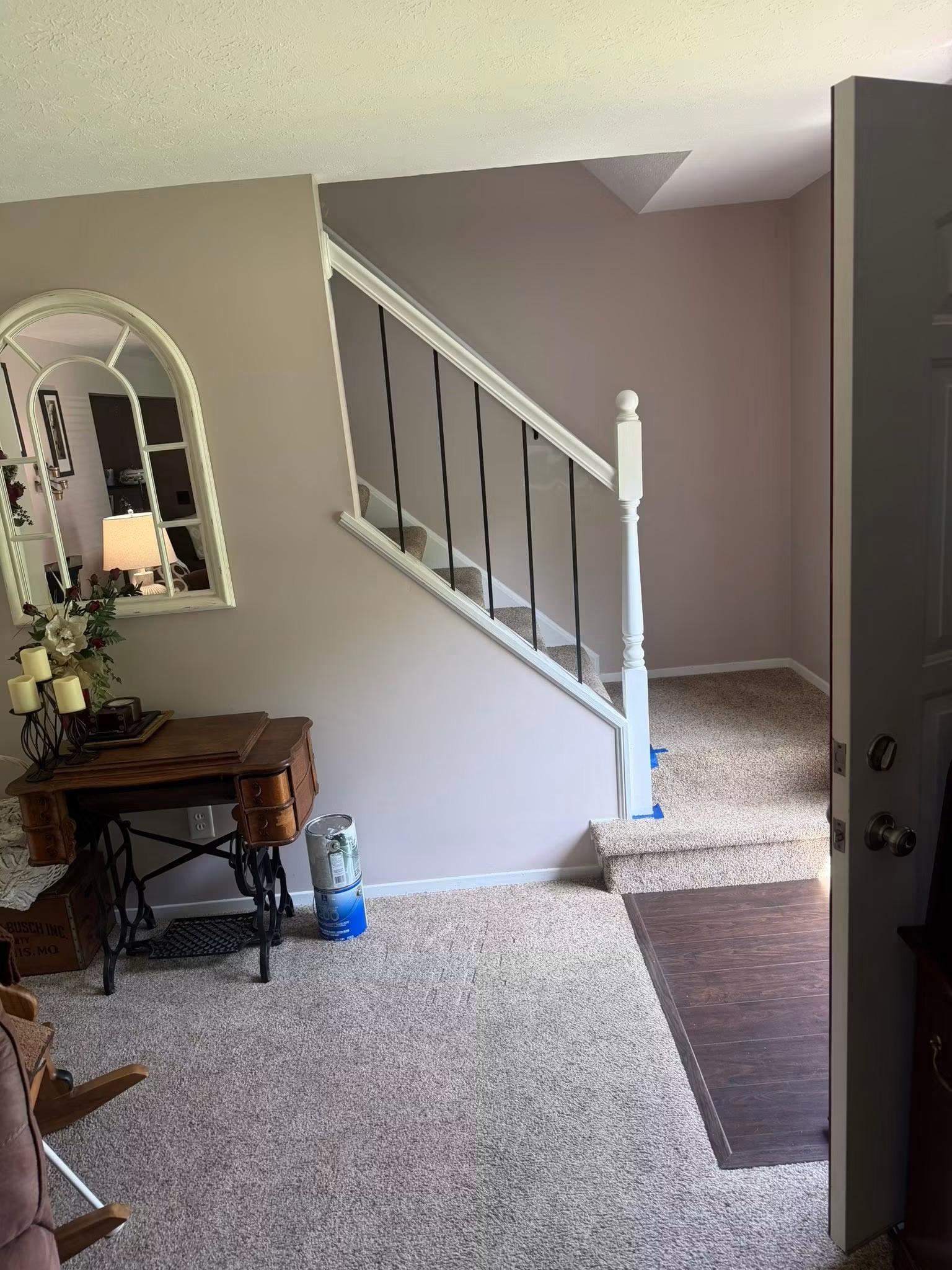 Freshly painted stairwell and entryway with white trim
