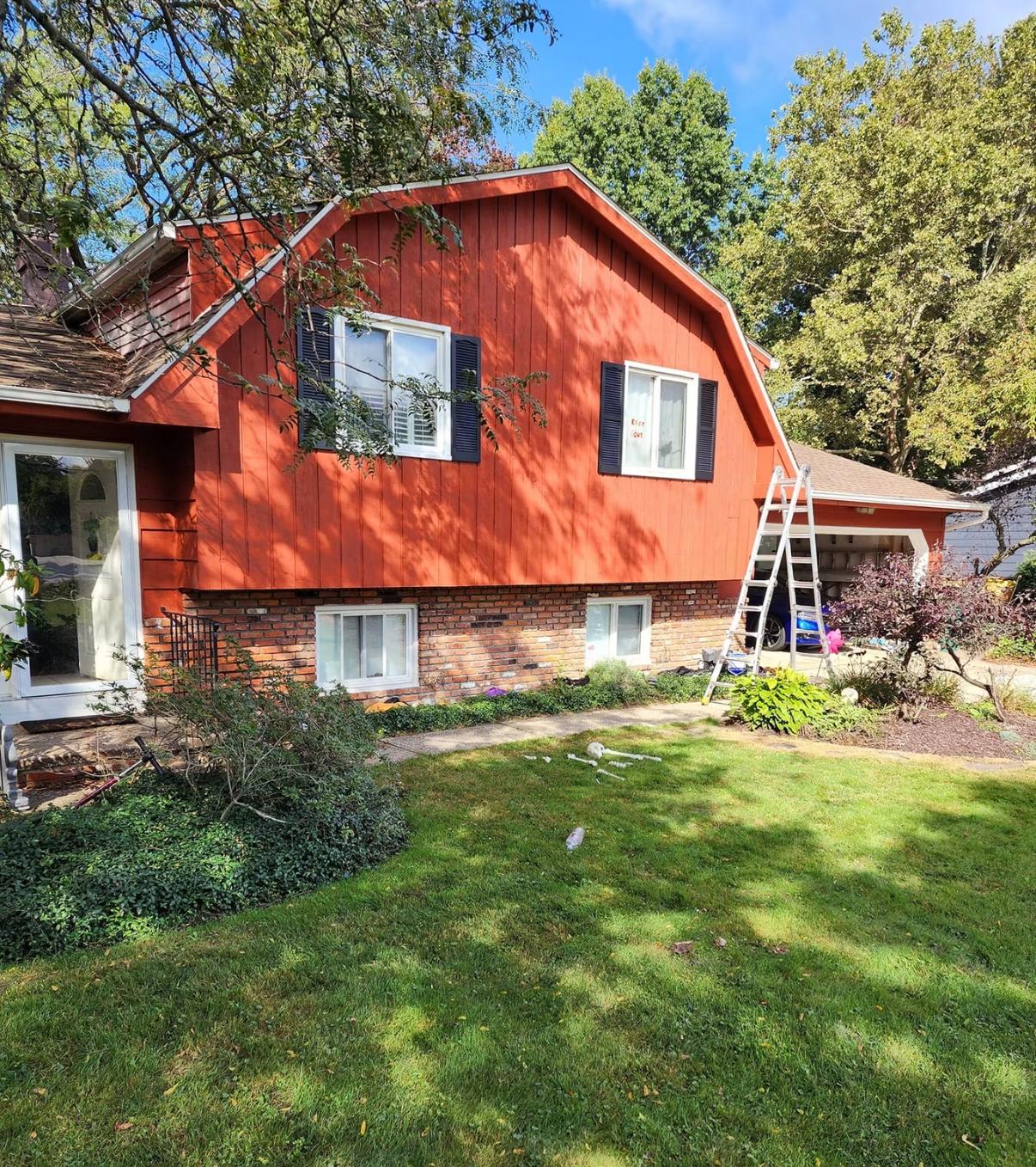 Home exterior with board-and-batten siding painted a rich red